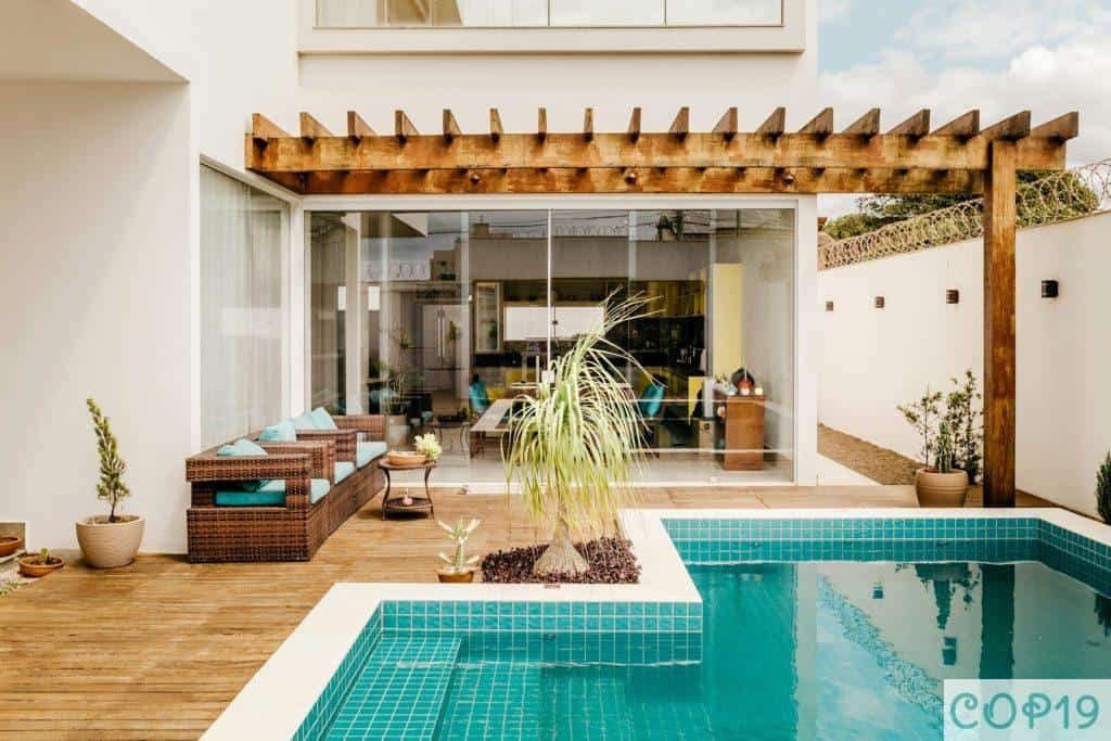 brown wooden table near swimming pool