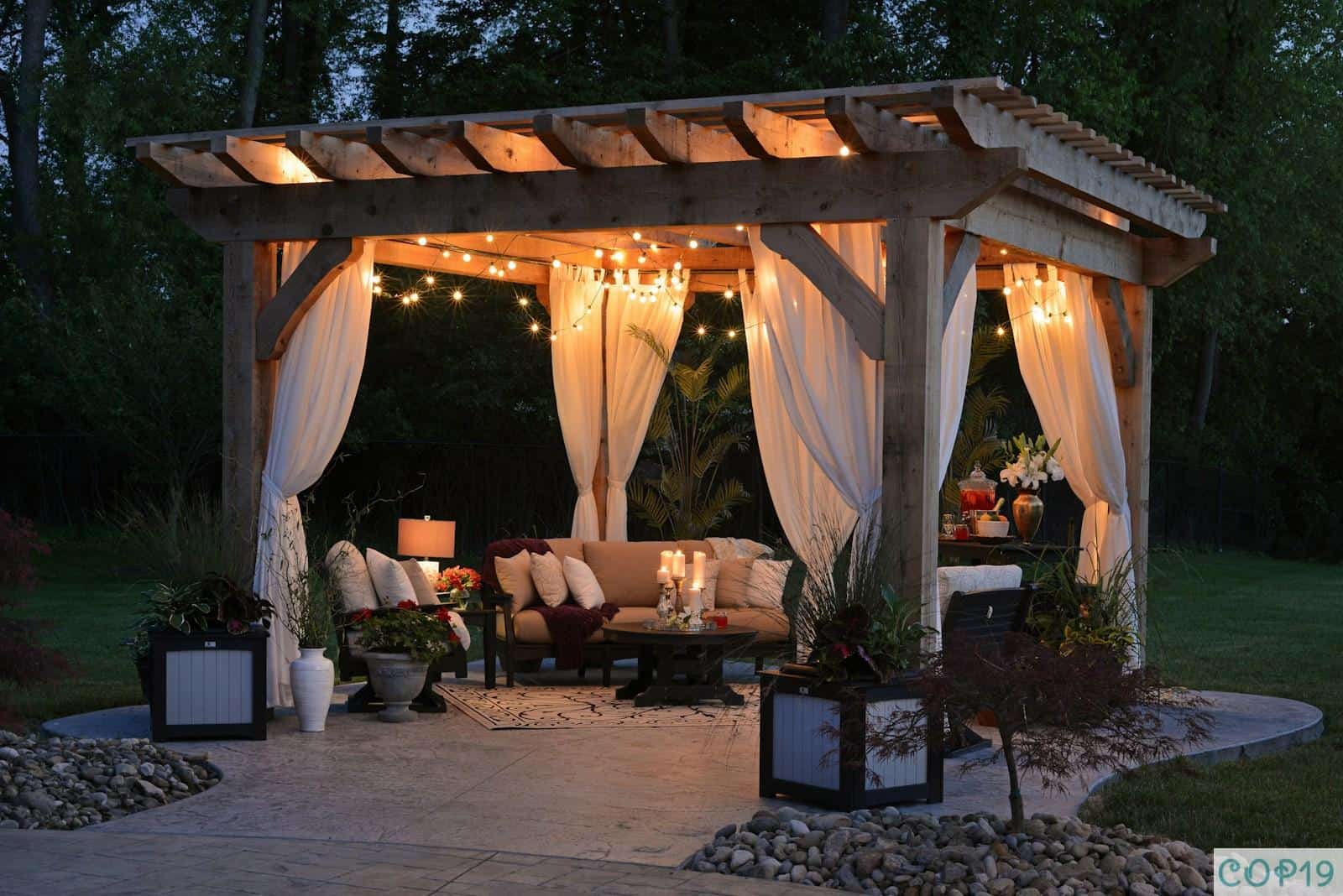 photo of gazebo with curtain and string lights