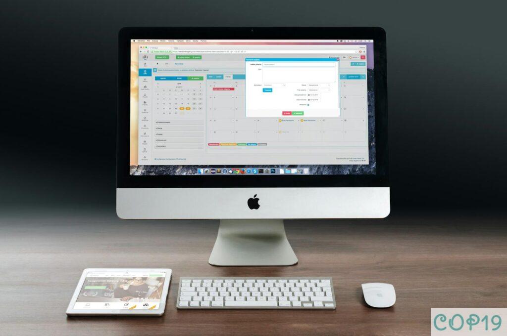 Silver Imac, Apple Magic Keyboard, and Magic Mouse on Wooden Table